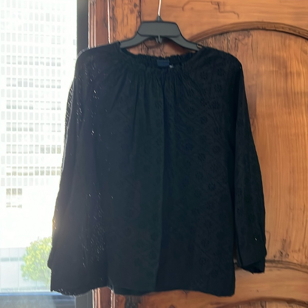 Beautiful eyelet blouse, wear year round with different camosoles underneath.